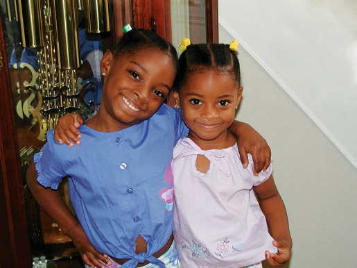 Young Simone and Adria Biles standing together
